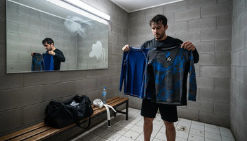 BJJ athlete comparing rashguards in locker room