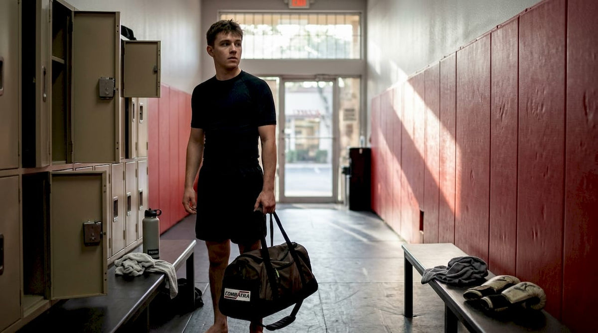 Beginner dressed in no-gi BJJ attire entering gym