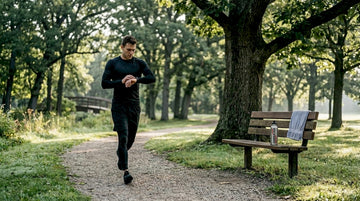 Athlete jogging outdoors in rashguard and sleeves