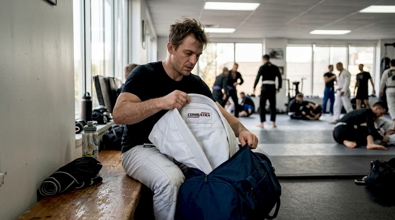 BJJ athlete unpacking gym bag essentials