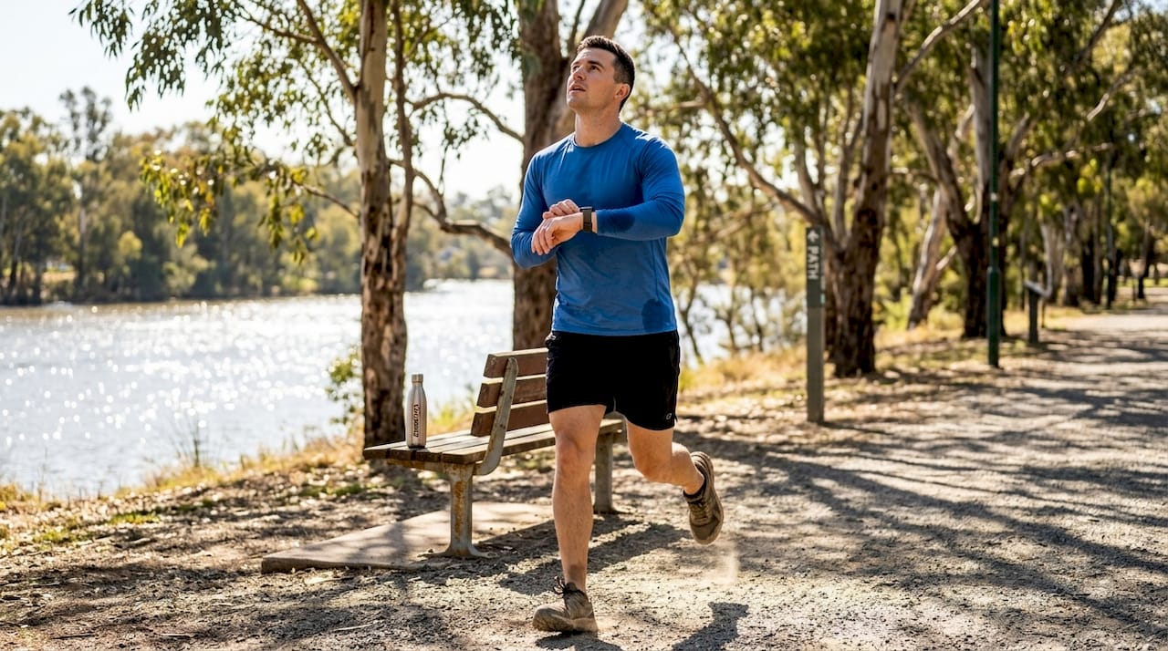 Athlete running in sun wearing blue rashguard