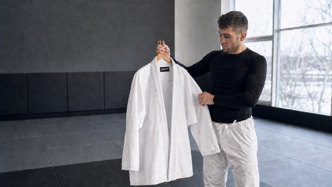 Combatra athlete reviewing a white BJJ gi jacket with the live-style black woven neck label