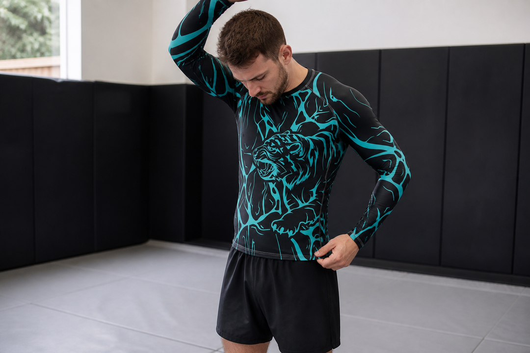 Athlete checking the hem of a Combatra Energy Tiger rashguard in a BJJ academy